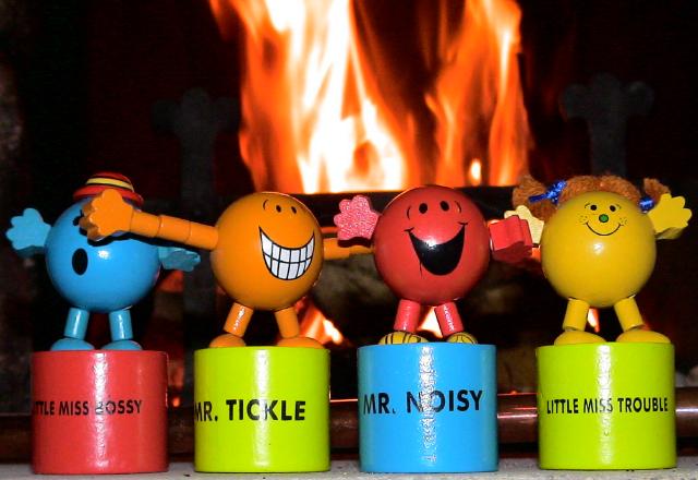 Little Miss Bossy, Mr Tickle, Mr Noisy and Little Miss Trouble ... with their backs to the inferno